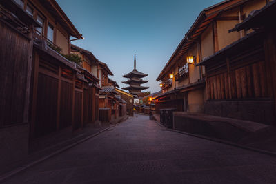 Street amidst buildings against sky in city