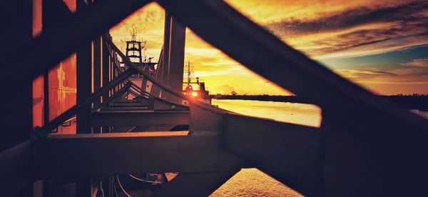 Silhouette bridge against sky during sunset