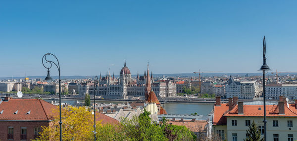 Buildings in city against blue sky