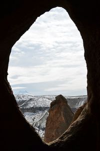 Scenic view of mountains against cloudy sky