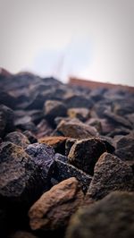 Close-up of rocks on land against sky