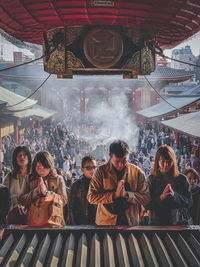 Group of people sitting in front of building