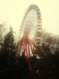 Low angle view of ferris wheel against sky