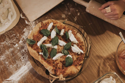 High angle view of pizza on wooden board