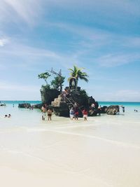 People on beach against sky