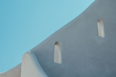 Low angle view of built structure against clear blue sky