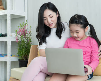 Portrait of smiling girl sitting at home