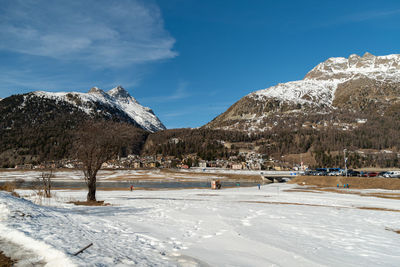 Silvaplana, switzerland, february 21, 2023 winter landscape scenery with a frozen lake of silvaplana