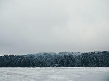 Frozen landscape against sky during winter