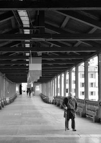 Rear view of people walking in corridor