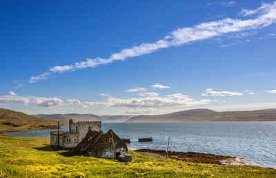 Scenic view of sea and buildings against sky