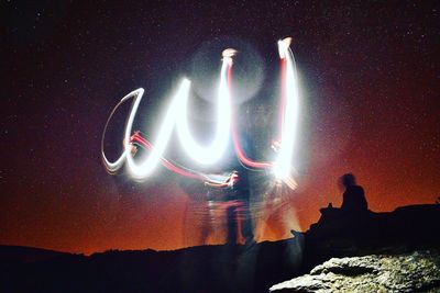 View of illuminated mountain against sky at night