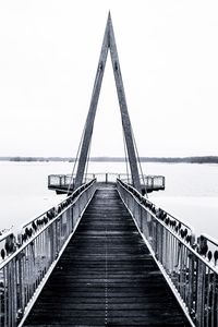 Bridge over sea against clear sky