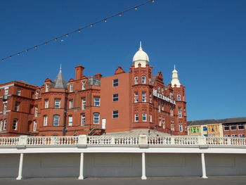 Low angle view of buildings against blue sky