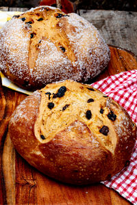 Round loaves of irish soda bread encrusted with sugar crystals on wood