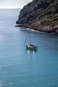 Sailboat on sea against sky