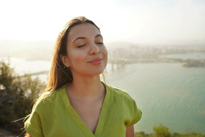 Happy traveler woman enjoying relaxed wind on face at sunset in her vacation in brazil. 