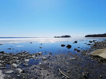 Scenic view of sea against clear blue sky