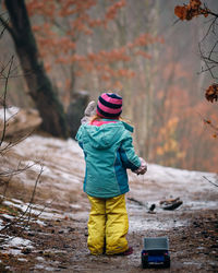 Full length rear view of boy in snow