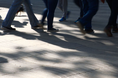 Low section of people walking on street