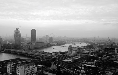 High angle view of cityscape against cloudy sky