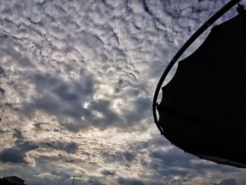 Low angle view of silhouette building against sky