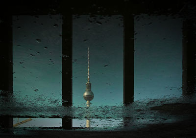 Upside down image of fernsehturm reflection in puddle