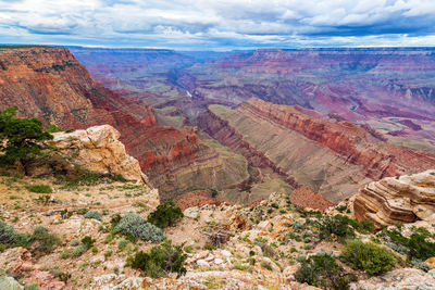 Scenic view of eroded landscape against cloudy sky at grand canyon national park