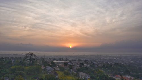 Scenic view of sunset over city