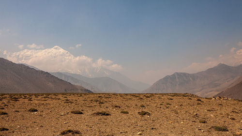 Scenic view of arid landscape against sky