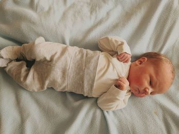 Directly above shot of baby boy lying on bed