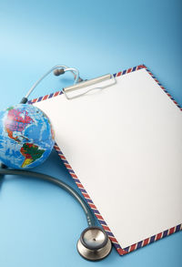 High angle view of book on table against blue background