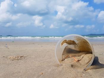 Plastic glass at the beach. pollution of environment by human