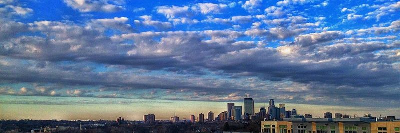 Cityscape against cloudy sky