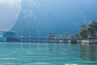 Scenic view of swimming pool by sea against sky