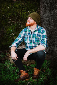 Young man looking at camera in forest