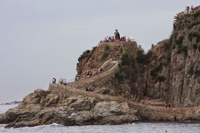 People on cliff at seaside