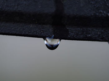 Close-up of raindrops on metal during rainy season