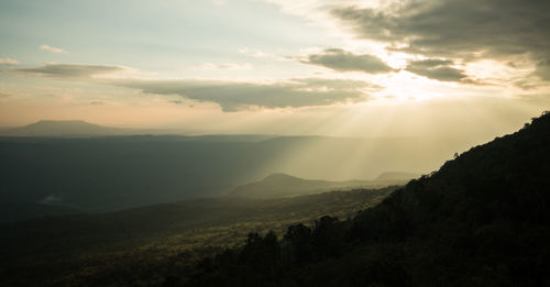 Scenic view of silhouette mountains against sky at sunset