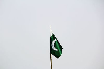 Low angle view of flag against clear sky