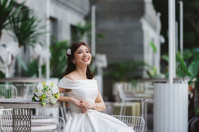 Portrait of a smiling young woman standing outdoors