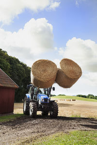 Tractor carrying bales of hay