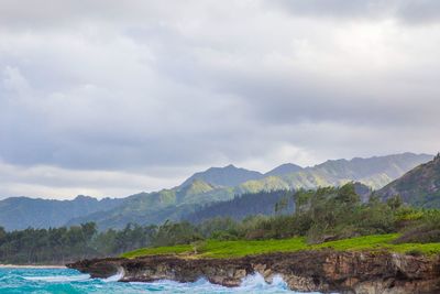 Scenic view of lake and mountains against sky