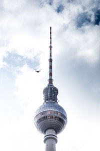 Low angle view of eiffel tower against cloudy sky