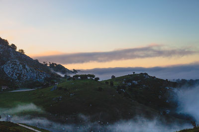 Scenic view of mountains against sky at sunset