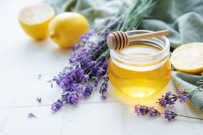 Glass of honey, honeycomb and lavender flowers