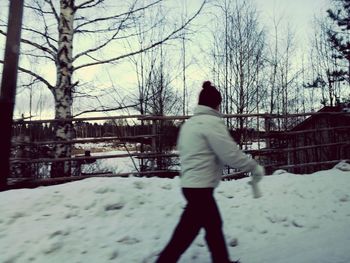 Rear view of man on snow covered landscape