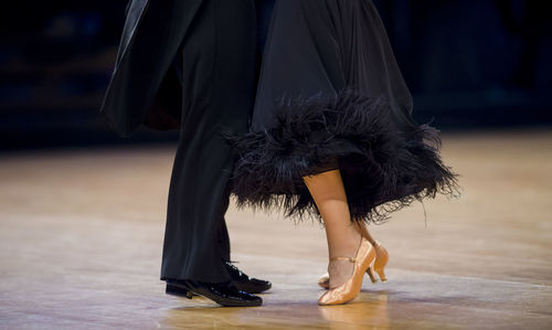 Low section of couple dancing on floor