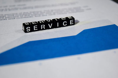 Close-up of information sign on table