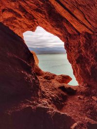 Scenic view of sea seen through cave